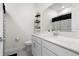 Bright bathroom featuring a large mirror, white vanity, and modern black shelving for an organized look at 884 Laurel View Way, Groveland, FL 34736