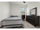 Cozy bedroom with a comfortable bed, matching dresser, large mirror, and soft carpet at 884 Laurel View Way, Groveland, FL 34736