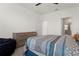 Comfortable bedroom with blue accents, carpeted floor, and a door leading to the bathroom at 884 Laurel View Way, Groveland, FL 34736