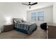 Cozy bedroom with neutral carpet, ceiling fan, and two windows providing natural light at 884 Laurel View Way, Groveland, FL 34736