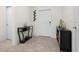 Inviting entryway featuring neutral tile flooring, decorative shelving and coat rack at 884 Laurel View Way, Groveland, FL 34736