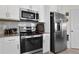 Kitchen with stainless steel appliances, granite countertops, and white cabinets at 884 Laurel View Way, Groveland, FL 34736