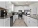 Modern kitchen featuring white cabinets, stainless steel appliances, and beautiful countertops at 884 Laurel View Way, Groveland, FL 34736
