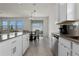 Bright kitchen with a view of the dining area and sliding glass doors leading to the outdoor space at 884 Laurel View Way, Groveland, FL 34736