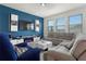 Bright living room with large windows, a plush sectional sofa, and a modern entertainment center at 884 Laurel View Way, Groveland, FL 34736
