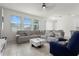Spacious living room with ample seating, tile floors, and direct access to the dining area at 884 Laurel View Way, Groveland, FL 34736