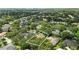 Panoramic aerial of homes in leafy suburb; one home outlined in white at 9491 Wickham Way, Orlando, FL 32836