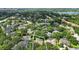 Aerial view of homes in a leafy neighborhood, one outlined in white showing pool at 9491 Wickham Way, Orlando, FL 32836