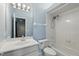 A well-maintained bathroom features a combined shower and tub and a vanity with a large mirror at 9491 Wickham Way, Orlando, FL 32836