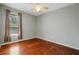 A light-filled bedroom with hardwood floors is warmed by natural light and is ready for personalization at 9491 Wickham Way, Orlando, FL 32836