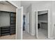A walk-in closet offers ample storage space with shelves, drawers, and custom organizers for clothes and accessories at 9491 Wickham Way, Orlando, FL 32836