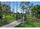 Community dog park area with tall pines and green grass at 9491 Wickham Way, Orlando, FL 32836