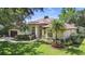 Beautiful single-story home with manicured lawn, mature palm trees, and well-maintained landscaping at 9491 Wickham Way, Orlando, FL 32836