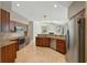 Modern kitchen featuring stainless steel appliances, granite countertops, and wooden cabinets at 9491 Wickham Way, Orlando, FL 32836