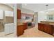 Bright kitchen with wooden cabinets, granite countertops, and stainless steel appliances at 9491 Wickham Way, Orlando, FL 32836