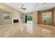 Light-filled living room featuring a decorative fireplace, marble floors, and pool access at 9491 Wickham Way, Orlando, FL 32836