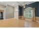 Living room featuring high ceilings, a large arched window, and marble floors at 9491 Wickham Way, Orlando, FL 32836