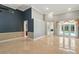 Bright, spacious living room features large windows, high ceilings, and elegant marble floors at 9491 Wickham Way, Orlando, FL 32836