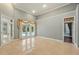 Open living room with pool access and hardwood flooring in connecting hallway at 9491 Wickham Way, Orlando, FL 32836