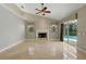 Inviting living room featuring a fireplace, marble floors, and sliding glass doors to the pool at 9491 Wickham Way, Orlando, FL 32836