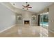 Bright living room with fireplace and access to the pool area through sliding glass doors at 9491 Wickham Way, Orlando, FL 32836