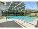 Enjoy a refreshing dip in this screened-in pool with lush landscaping and great views of the home's exterior at 9491 Wickham Way, Orlando, FL 32836