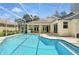 The sparkling screened-in pool offers a perfect spot to relax and enjoy the outdoors, adjacent to the home's exterior at 9491 Wickham Way, Orlando, FL 32836