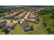 Aerial view of a neighborhood showcasing a home with a private screened-in pool at 4111 Oaktree Dr, Davenport, FL 33837
