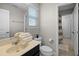 Bright bathroom featuring a black vanity, neutral walls, and a window with white blinds at 4111 Oaktree Dr, Davenport, FL 33837