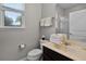 Well-lit bathroom with neutral colors, stacked towels, and a window view at 4111 Oaktree Dr, Davenport, FL 33837