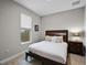 Bedroom with a dark wood bed and side table, features a window at 4111 Oaktree Dr, Davenport, FL 33837