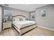 Bedroom featuring a king bed, wood floors, and two windows with blinds at 4111 Oaktree Dr, Davenport, FL 33837