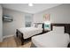 Bedroom with two beds, wood floors, television, and window with blinds at 4111 Oaktree Dr, Davenport, FL 33837