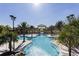 Stunning community pool with palm trees, lounge chairs, and an arched entrance, creating a resort-like atmosphere at 4111 Oaktree Dr, Davenport, FL 33837
