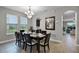 Elegant dining room with a chandelier and a view of the backyard through large windows at 4111 Oaktree Dr, Davenport, FL 33837