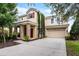 Charming two-story home with stone accents, a two-car garage, and mature landscaping at 4111 Oaktree Dr, Davenport, FL 33837