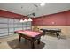 This game room features a pool table, air hockey, and bright lighting for entertaining guests at 4111 Oaktree Dr, Davenport, FL 33837