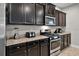 Close-up of a kitchen showcasing stainless steel appliances and granite countertops at 4111 Oaktree Dr, Davenport, FL 33837