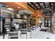 Modern kitchen and food preparation area featuring a stainless hood, equipment, and counter seating at 4111 Oaktree Dr, Davenport, FL 33837