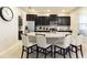 Modern kitchen featuring dark cabinetry, granite countertops, and a center island with seating at 4111 Oaktree Dr, Davenport, FL 33837