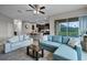 Open-concept living room with modern furnishings and seamless access to the screened lanai at 4111 Oaktree Dr, Davenport, FL 33837