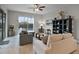 Bright living room features tile floors, comfortable seating, and a large window with a view of the pool at 4111 Oaktree Dr, Davenport, FL 33837