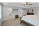 Spacious main bedroom featuring wood-look floors, tray ceiling, and ensuite bathroom at 4111 Oaktree Dr, Davenport, FL 33837