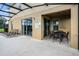 Covered patio with outdoor seating, lounge chairs, and access to the pool area through sliding glass doors at 4111 Oaktree Dr, Davenport, FL 33837