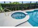 A hot tub and in-ground pool are surrounded by a screen enclosure for privacy, protection, and enjoyment at 4111 Oaktree Dr, Davenport, FL 33837