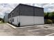 Condo building exterior with large gray roof and white walls, situated beside a parking area at 1000 S Semoran Blvd # 415, Winter Park, FL 32792