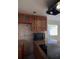 Modern kitchen featuring a tile backsplash, wood cabinets, and sleek countertops at 1000 S Semoran Blvd # 415, Winter Park, FL 32792
