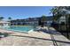 Community pool with lounge seating and palm trees, offering a refreshing and relaxing atmosphere at 1000 S Semoran Blvd # 415, Winter Park, FL 32792