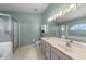 Bathroom featuring double sinks, shower, and separate bathtub at 1021 Piedmont Oaks Dr, Apopka, FL 32703