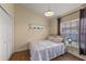 Bedroom with wood floors, closet, window with blinds, and neutral paint at 1021 Piedmont Oaks Dr, Apopka, FL 32703